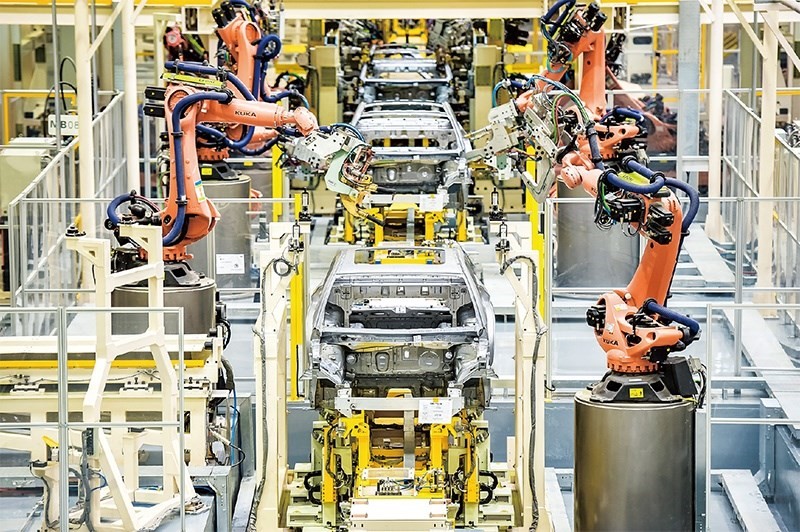 發(fā)展新能源汽車是我國從汽車大國邁向汽車強(qiáng)國的必由之路。2022年中國新能源汽車產(chǎn)銷分別實(shí)現(xiàn)705.8萬輛和688.7萬輛，連續(xù)8年位居世界第一。圖為廣汽埃安第一智造中心焊裝車間正在熱火朝天地生產(chǎn)。 廣汽埃安新能源汽車股份有限公司供圖