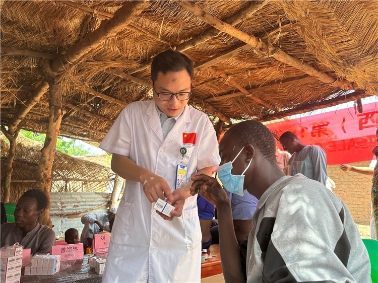 圖為南昌大學(xué)第一附屬醫(yī)院病理科主治醫(yī)師張振東為村民解說藥品使用方法。中國(guó)駐乍得醫(yī)療隊(duì)供圖