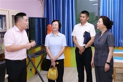 圖③：“小公民法律課堂”開(kāi)講前，全國(guó)人大代表殷其龍（右二）、重慶市人大代表李自玲（左二）聽(tīng)取楊家坪中學(xué)負(fù)責(zé)人關(guān)于未成年人思想教育工作情況的介紹。