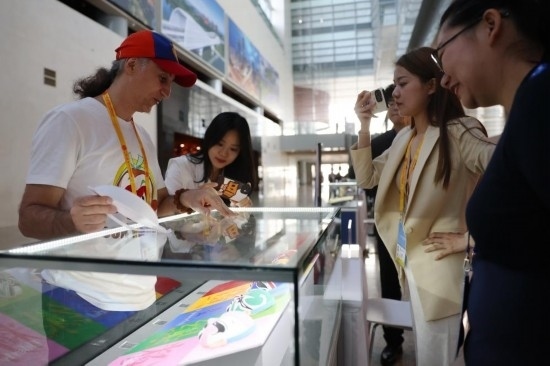 10月16日，參會(huì)記者在“一帶一路”國(guó)際合作高峰論壇新聞中心參觀展示的中國(guó)非物質(zhì)文化遺產(chǎn)展品。新華社記者 陳斌 攝