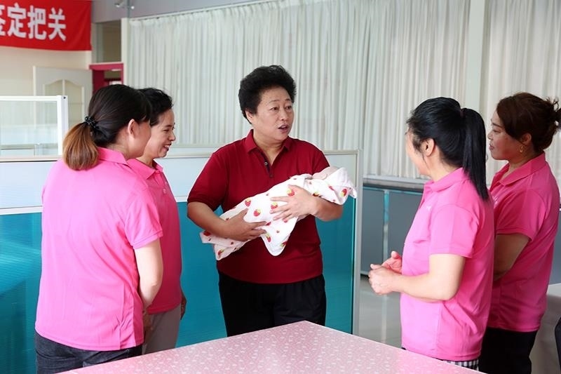 △2021年6月2日，卓長立（中）指導(dǎo)正在接受培訓(xùn)的家政服務(wù)員。