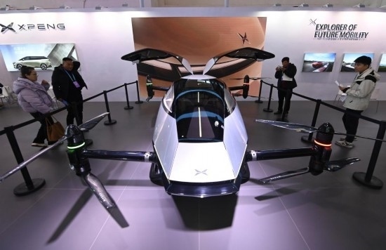 2023年12月1日，在鏈博會(huì)智能汽車鏈展區(qū)小鵬汽車展臺(tái)，參觀者觀看一臺(tái)智能飛行器。新華社記者蔡湘鑫攝