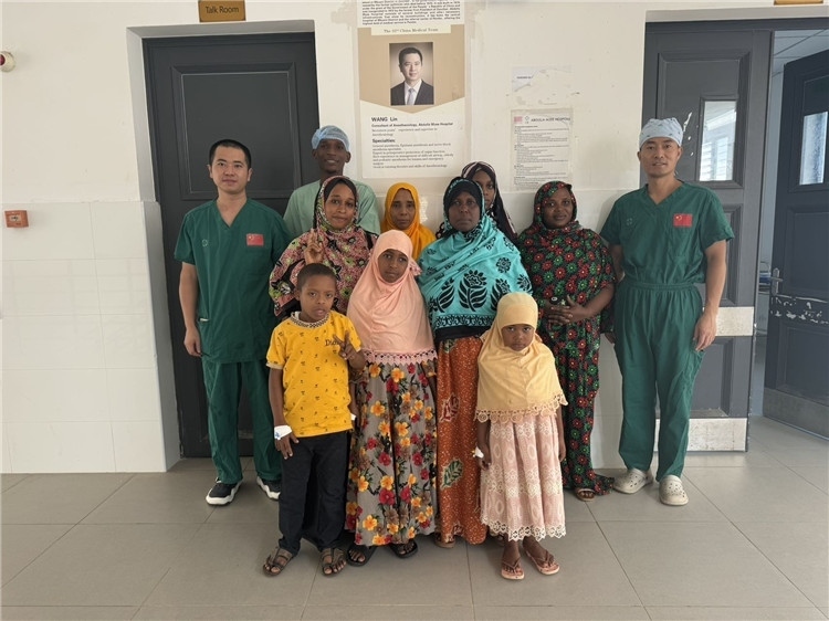 李廣（右一）和王林醫(yī)生與部分患者合影。中國(guó)援桑醫(yī)療隊(duì)供圖