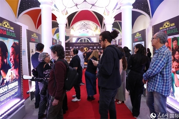 為期4天的第三屆中國(guó)－巴西電影展期間，來(lái)自中巴兩國(guó)的14部參展影片受到巴西電影愛(ài)好者和社會(huì)各界人士好評(píng)，圖為當(dāng)?shù)赜^眾在影展舉辦地巴西里約熱內(nèi)盧勞拉—阿爾維姆文化之家的迎賓廳欣賞參展電影海報(bào)。 人民網(wǎng)記者 陳一鳴攝
