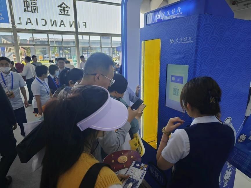 觀眾在金融服務(wù)展區(qū)體驗數(shù)字人民幣購物。人民網(wǎng)記者 黃盛攝