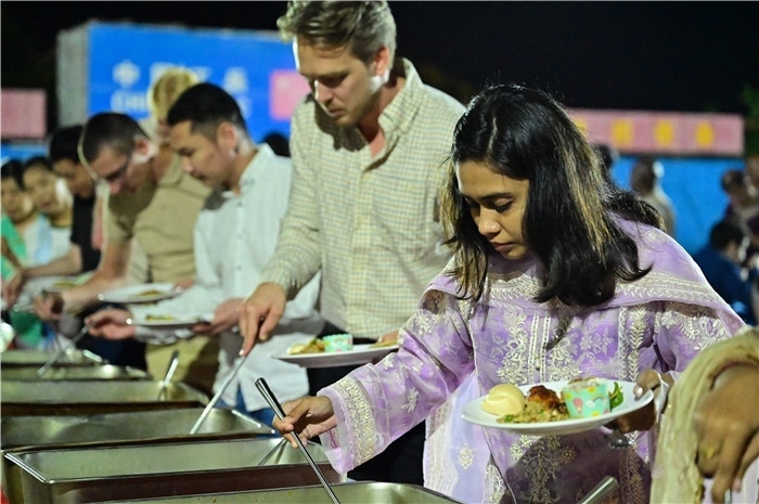 外國(guó)友人品嘗中國(guó)美食。馬騫攝