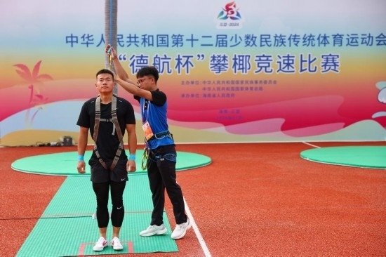 11月23日，工作人員為上海隊選手付樂樂（左）系安全繩。新華社記者 楊植森 攝