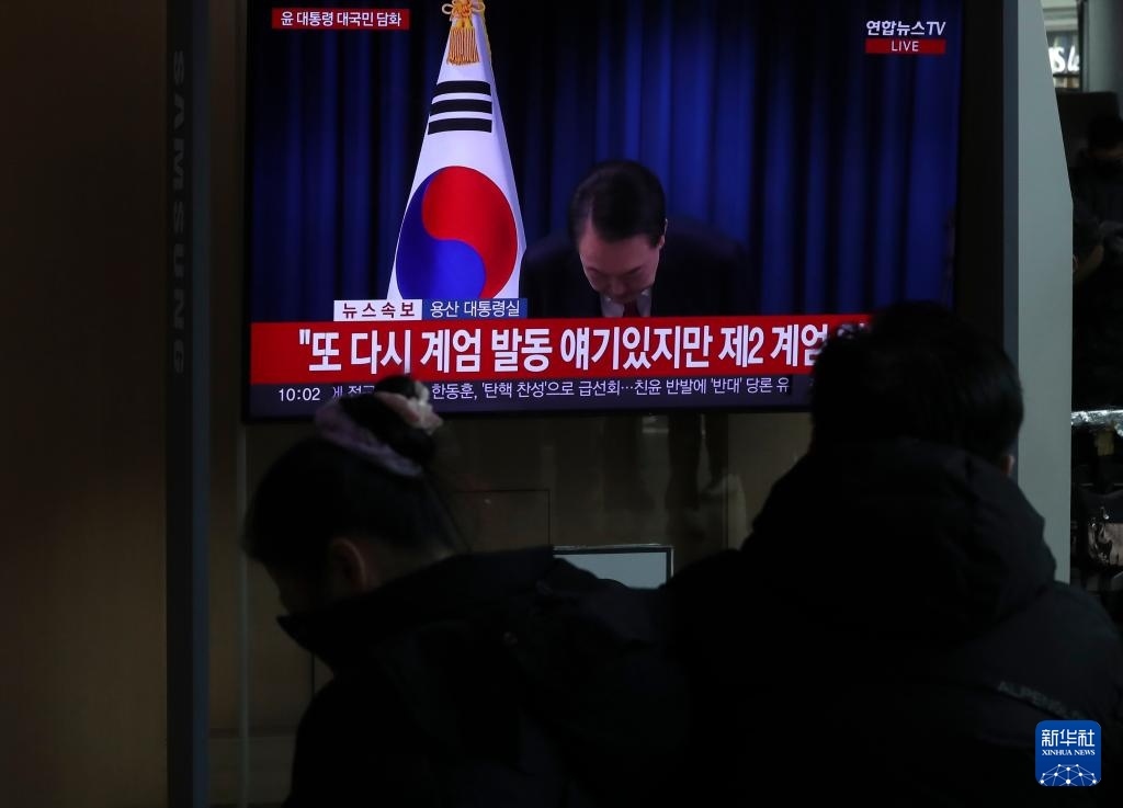 12月7日，在韓國首爾火車站，民眾觀看總統(tǒng)尹錫悅發(fā)表講話的電視畫面。新華社記者 姚琪琳 攝