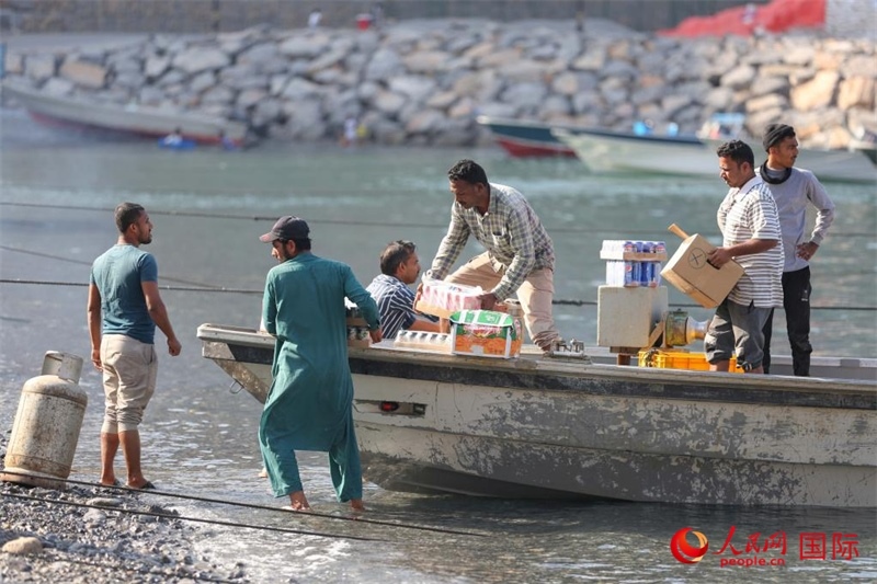 當(dāng)?shù)厝藗冊谶\(yùn)送生活物資。人民網(wǎng) 塔里克·易卜拉欣攝