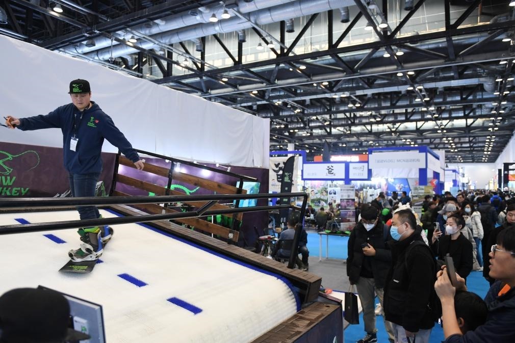2023年2月11日，參觀者在展會(huì)上了解一款模擬滑雪設(shè)備。當(dāng)日，2023亞洲運(yùn)動(dòng)用品與時(shí)尚展在國家會(huì)議中心拉開帷幕。新華社記者 張晨霖 攝