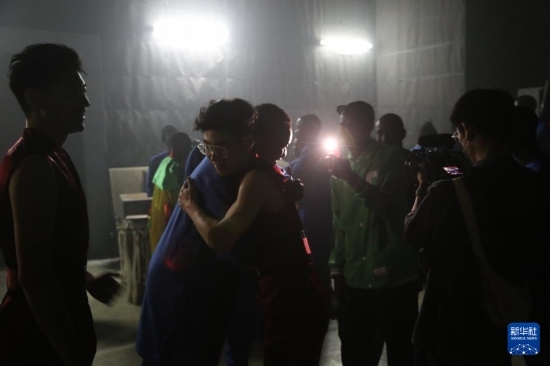 4月10日，在塞內(nèi)加爾首都達(dá)喀爾的國家大劇院，中央音樂學(xué)院進(jìn)擊打擊樂團(tuán)成員與塞內(nèi)加爾杜杜·恩迪亞耶·羅斯打擊樂團(tuán)成員在演出后臺(tái)擁抱。新華社記者 司源 攝